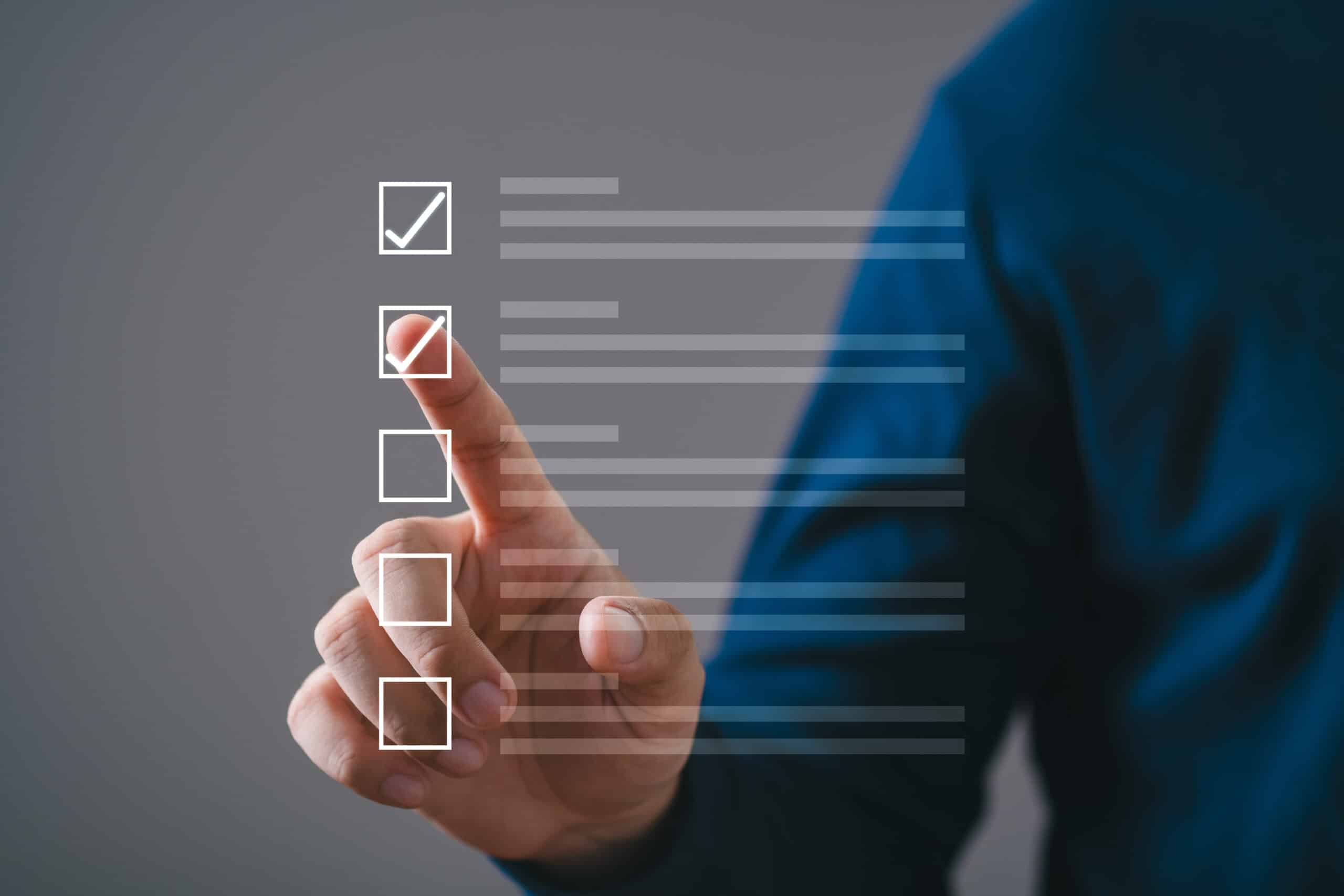 Person tapping virtual checklist on transparent screen, symbolizing tasks, productivity, and digital organization on a solid background.